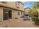 Charming brick back patio featuring an outdoor dining set and sliding glass door access to the home at 1265 S Aaron -- # 355, Mesa, AZ 85209