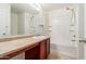 Bright bathroom with a large mirror, vanity, and combined tub and shower at 1265 S Aaron -- # 355, Mesa, AZ 85209
