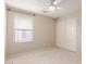Neutral-colored bedroom featuring carpet, closet, window with blinds and a ceiling fan at 1265 S Aaron -- # 355, Mesa, AZ 85209