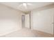 Neutral-colored bedroom with carpet, white closet doors, ceiling fan and passage to another room at 1265 S Aaron -- # 355, Mesa, AZ 85209