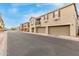 Street view of townhomes with two-car garages and neutral colored stucco at 1265 S Aaron -- # 355, Mesa, AZ 85209