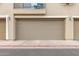 Close up of the two car garage with neutral door in a stucco townhome at 1265 S Aaron -- # 355, Mesa, AZ 85209