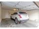 A spacious garage with a white car parked inside, offering secure parking at 1265 S Aaron -- # 355, Mesa, AZ 85209