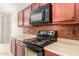 A kitchen featuring stainless steel appliances, sleek countertops, and a mosaic backsplash at 1265 S Aaron -- # 355, Mesa, AZ 85209