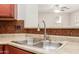 Close up of kitchen stainless steel sink and faucet, with tile backsplash detail at 1265 S Aaron -- # 355, Mesa, AZ 85209