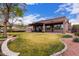 Expansive backyard with well-maintained lawn, patio with pergola, and manicured landscaping at 1312 N Joplin Cir, Mesa, AZ 85207