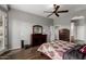 Bedroom features hardwood floors, a dresser with a mirror, and a ceiling fan for comfortable living at 1312 N Joplin Cir, Mesa, AZ 85207