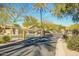 Community entrance with wrought iron gates, desert landscaping, and stone pillars at 1312 N Joplin Cir, Mesa, AZ 85207