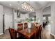 Beautiful dining room with stylish lighting, wood flooring, and an open view of the kitchen at 1312 N Joplin Cir, Mesa, AZ 85207