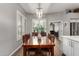 Inviting dining room with stylish lighting, plantation shutters, and wood flooring at 1312 N Joplin Cir, Mesa, AZ 85207