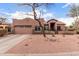 Single level home with two-car garage and desert landscaping provides great curb appeal at 1312 N Joplin Cir, Mesa, AZ 85207