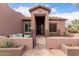 Gated front courtyard with seating area at a single level home at 1312 N Joplin Cir, Mesa, AZ 85207