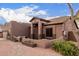 Single level home with gated front patio, desert landscaping and walkway at 1312 N Joplin Cir, Mesa, AZ 85207