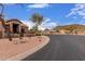 Single level home with gated front patio, desert landscaping and walkway at 1312 N Joplin Cir, Mesa, AZ 85207