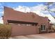A large two-car garage with desert landscaping on a single level home at 1312 N Joplin Cir, Mesa, AZ 85207