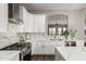 Well-lit modern kitchen with stainless steel appliances, countertops, and ample cabinet space at 1312 N Joplin Cir, Mesa, AZ 85207