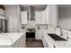 Modern kitchen features white cabinets, stainless steel appliances, stone countertops, and a stylish backsplash at 1312 N Joplin Cir, Mesa, AZ 85207