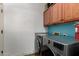 Functional laundry room features modern washer and dryer, cabinet storage and counter space at 1312 N Joplin Cir, Mesa, AZ 85207
