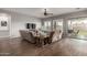 Spacious living room featuring a ceiling fan, wood flooring, and sliding glass doors to the backyard at 1312 N Joplin Cir, Mesa, AZ 85207