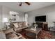 Cozy living room featuring comfortable sofas, a decorative rug, and a large-screen TV at 1312 N Joplin Cir, Mesa, AZ 85207