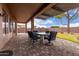 Covered outdoor patio with plenty of dining space and beautifully paved flooring at 1312 N Joplin Cir, Mesa, AZ 85207