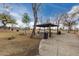 Community pavilion with picnic tables and trash receptacles along a walking path at 1312 N Joplin Cir, Mesa, AZ 85207