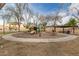 Community playground featuring mature trees, covered seating, and modern play equipment at 1312 N Joplin Cir, Mesa, AZ 85207