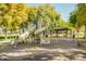 Community playground with slides, a swing, and a picnic area, providing a space for outdoor recreation and leisure at 1312 N Joplin Cir, Mesa, AZ 85207