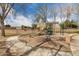 Community playground with modern play equipment surrounded by mature trees at 1312 N Joplin Cir, Mesa, AZ 85207