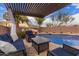 Inviting backyard pool area with covered patio, lounge furniture and a rock waterfall feature at 1312 N Joplin Cir, Mesa, AZ 85207