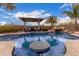 Gorgeous in-ground pool with tanning ledge, covered patio area and relaxing waterfall feature at 1312 N Joplin Cir, Mesa, AZ 85207