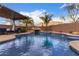 Beautiful in-ground swimming pool with rock waterfall feature and well manicured backyard landscaping at 1312 N Joplin Cir, Mesa, AZ 85207