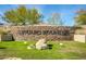 Stone sign for Saguaro Mountain community with well-manicured lawn and desert landscaping at 1312 N Joplin Cir, Mesa, AZ 85207