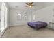 Large bedroom with carpet, ceiling fan, a balcony, arched windows, and plenty of natural light at 15469 W Dreyfus St, Surprise, AZ 85379