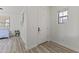 Bright entryway with white door, wood-look floors, and large window for natural light at 15469 W Dreyfus St, Surprise, AZ 85379