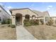 Charming single-story home with a cozy front porch and well-maintained landscaping, enhancing its curb appeal at 15469 W Dreyfus St, Surprise, AZ 85379