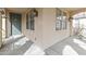 Covered front porch featuring an arched entryway and view of the beautiful green front door at 15469 W Dreyfus St, Surprise, AZ 85379