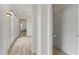 Hallway featuring hardwood floors, natural light, and convenient access to the powder room at 15469 W Dreyfus St, Surprise, AZ 85379