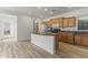 Spacious kitchen featuring an island with a sink, ample cabinet space, and modern appliances at 15469 W Dreyfus St, Surprise, AZ 85379