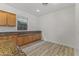 A pantry with plenty of cabinet space with granite countertops and a light wood floor at 15469 W Dreyfus St, Surprise, AZ 85379