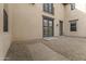 Private patio with rock landscaping, direct access to the home, and views of the upper-level balcony at 15469 W Dreyfus St, Surprise, AZ 85379