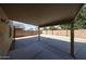 A spacious, covered back patio overlooking a large fenced-in yard, offering ample room for outdoor entertaining at 16640 W Polk St, Goodyear, AZ 85338