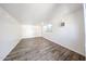 Bonus room with wood-look flooring, neutral paint, and window for natural light at 16640 W Polk St, Goodyear, AZ 85338