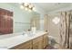 Bright bathroom with a large vanity, mirror, and tub/shower combo at 16923 E Last Trail Dr, Fountain Hills, AZ 85268