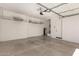 Spacious garage with shelving, water heater, and a clean epoxy-coated floor at 1933 N 140Th Ave, Goodyear, AZ 85395