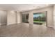 Bright and airy living room featuring tile flooring, recessed lighting, and access to the backyard at 1933 N 140Th Ave, Goodyear, AZ 85395