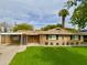 Charming single-story brick home with a well-manicured lawn and a quaint covered parking area at 1940 E Montebello Ave, Phoenix, AZ 85016