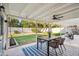 A covered patio with a dining set and ceiling fan, perfect for outdoor entertaining at 1940 E Montebello Ave, Phoenix, AZ 85016