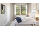 Cozy bedroom with a plush bed, natural light from a large window, and neutral decor throughout at 20301 W Turney Ave, Buckeye, AZ 85396