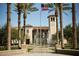 Upscale community featuring fountains, palm trees, well-manicured landscaping, a clock tower, and the American flag waving above at 20301 W Turney Ave, Buckeye, AZ 85396